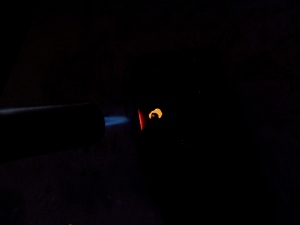 Using a torch to heat copper scrap to an annealed state.  It's a dull red glow.